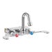 A T&S wall-mounted workboard faucet with gooseneck spout and wrist action handles.