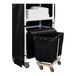 A Royal Basket Trucks black laundry cart with a black shelf and black bin full of white towels.