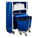 A blue Royal Basket Towel Station cart with a blue and white laundry bin on top.