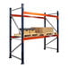 A blue and orange Interlake Mecalux heavy-duty metal pallet rack with boxes on the shelves.