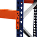A close-up of a blue and orange Interlake Mecalux heavy-duty pallet rack with shelves.