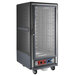 A gray Metro C5 heated holding and proofing cabinet with clear doors on wheels.