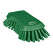 A green Vikan scrub brush with a handle and extra stiff bristles.