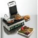 A Waring Panini sandwich grill with a sandwich on it.