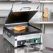 A Waring Tostato Supremo Panini Grill with a toasted sandwich on it.