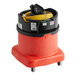 A red and black NaceCare Solutions canister vacuum on wheels with a black handle and yellow cords.