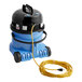 A blue NaceCare Solutions carpet spot extractor with a yellow cord.