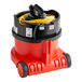 A red and black NaceCare Solutions ProSave canister vacuum with a hose attached to it.