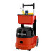 A red and black NaceCare Solutions Latitude cordless canister vacuum with a bucket.