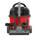 A red and black NaceCare Solutions cordless canister vacuum cleaner with a hose.