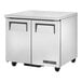 A stainless steel True TUC-36-HC undercounter refrigerator with wheels and two doors.