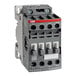A grey electrical contactor with white switches.