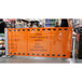 An orange ZonePro safety banner on a metal stanchion.