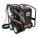 A Mi-T-M hot water pressure washer with a hose attached to it and wheels.