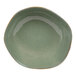 A green bowl with a brown rim on a white surface.
