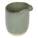 A green ceramic Front of the House Artefact creamer pitcher with a handle.