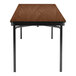 A brown rectangular National Public Seating table with a wooden top and black T-molded edges.