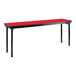 A red table with black legs and a black T-molded edge.