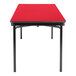 A red rectangular National Public Seating plywood folding table with black legs.