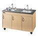A maple double basin Ozark River portable sink with black countertops.
