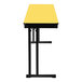 A yellow rectangular National Public Seating folding table with black edges and cantilever legs.