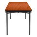 A National Public Seating rectangular wooden folding table with black T-mold edges.