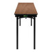 A National Public Seating Montana Walnut plywood folding table with T-mold edge and black legs.