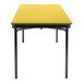 A National Public Seating marigold rectangular plywood table with black T-molded edges.