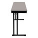 A gray National Public Seating folding table with a black base.