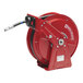 A red metal Reelcraft hose reel with a hose.