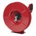 A red metal Reelcraft hose reel with a black handle.