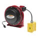 A red and black Reelcraft power cord reel with a yellow GFCI duplex outlet box.