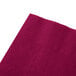A Hoffmaster burgundy paper napkin on a white surface.