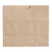 A natural brown Bagcraft paper bag with a hole in it.