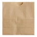 A close-up of a natural brown Bagcraft paper bag with a hole in it.