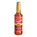 A Torani Almond Roca Flavoring Syrup 750 mL plastic bottle with a red label.