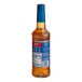 A plastic bottle of Torani Sugar-Free Classic Hazelnut Flavoring Syrup with a blue label.