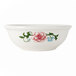 A white Tuxton china bowl with a flower design on the rim.