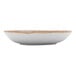 A white china salad bowl with a brown rim.