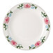 A white Tuxton Western Rose China plate with pink flowers and green leaves.