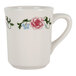 A white Tuxton Tiara mug with a floral design including pink flowers and green leaves.