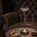 An Abert Tempo copper table lamp on a table with cigars.