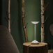 An Abert Tempo white table lamp with a white light on a table.