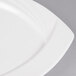 A close-up of a CAC Garden State bone white square porcelain plate with a curved edge.