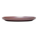 A Libbey Canyonlands mauve terracotta stoneware plate on a table.