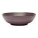 A close-up of a purple Libbey terracotta salad bowl with a black rim.