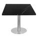 An Art Marble Italian black sintered stone table top on a square table with a metal base.