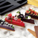 A variety of desserts made in a Pavoni silicone baking mold on a marble surface.