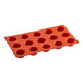 A red silicone Pavoni muffin baking mold with 15 compartments.