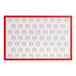 A white rectangular silicone baking mat with red circles.